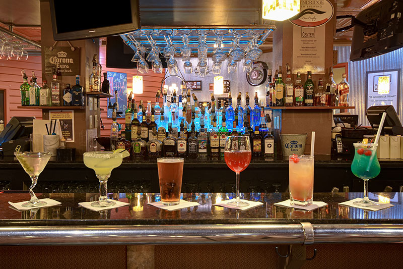 Cocktails and craft beer lined up on the bar at FenderZ